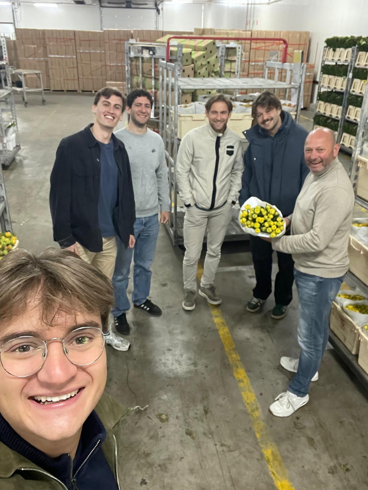 Team Lupin at the Tulpen.nl growing facility, with a grower holding a bunch of yellow tulips